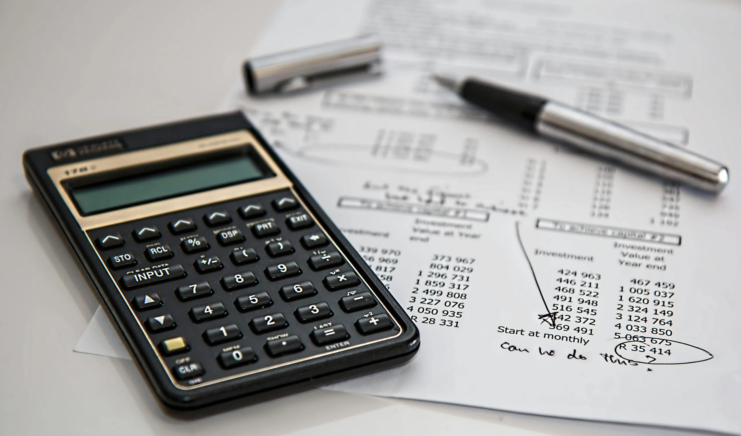 Home Close-up of financial documents with calculator and pen, ideal for business management themes.